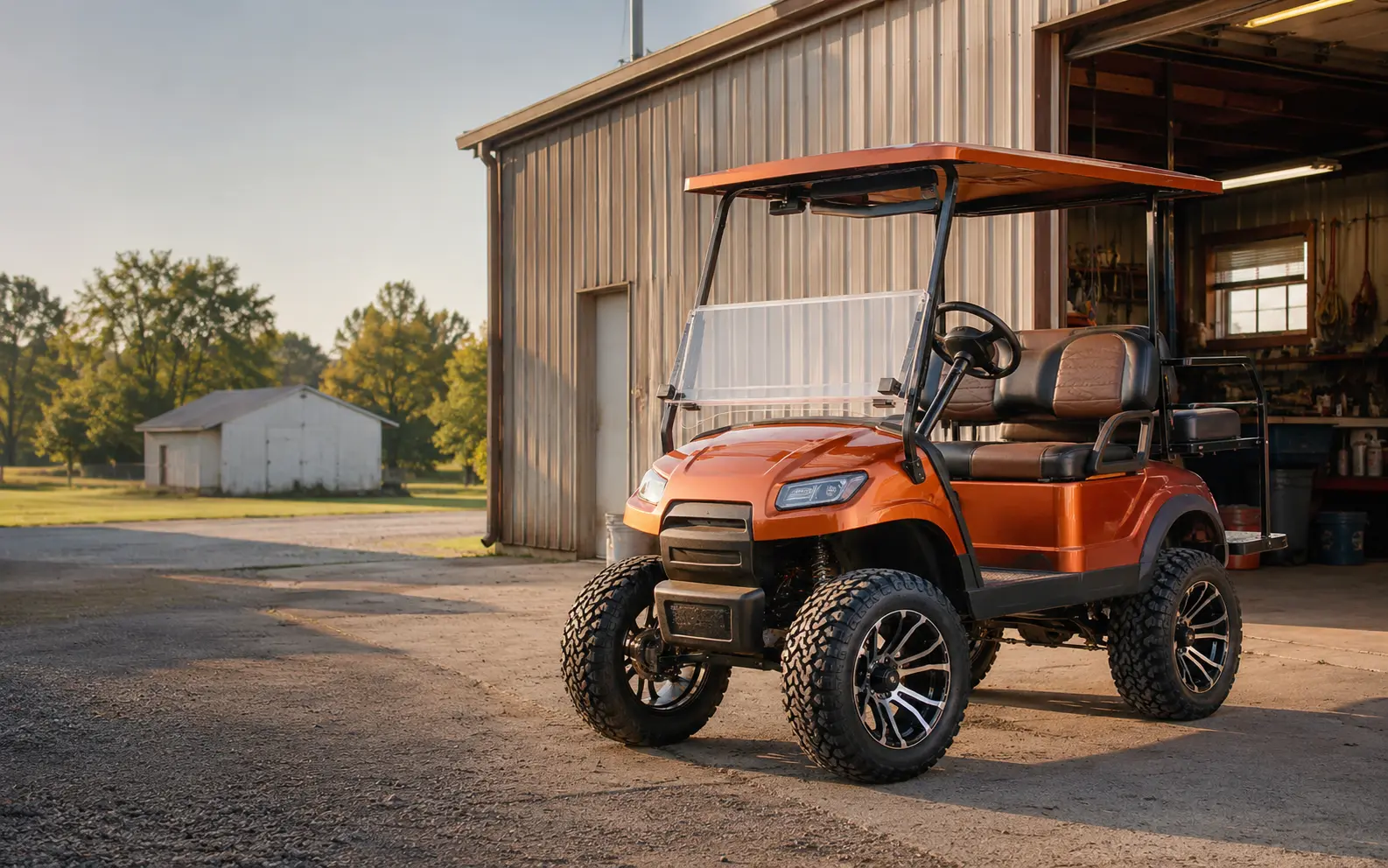 Orange lifted golf cart outside a neighborhood repair shop