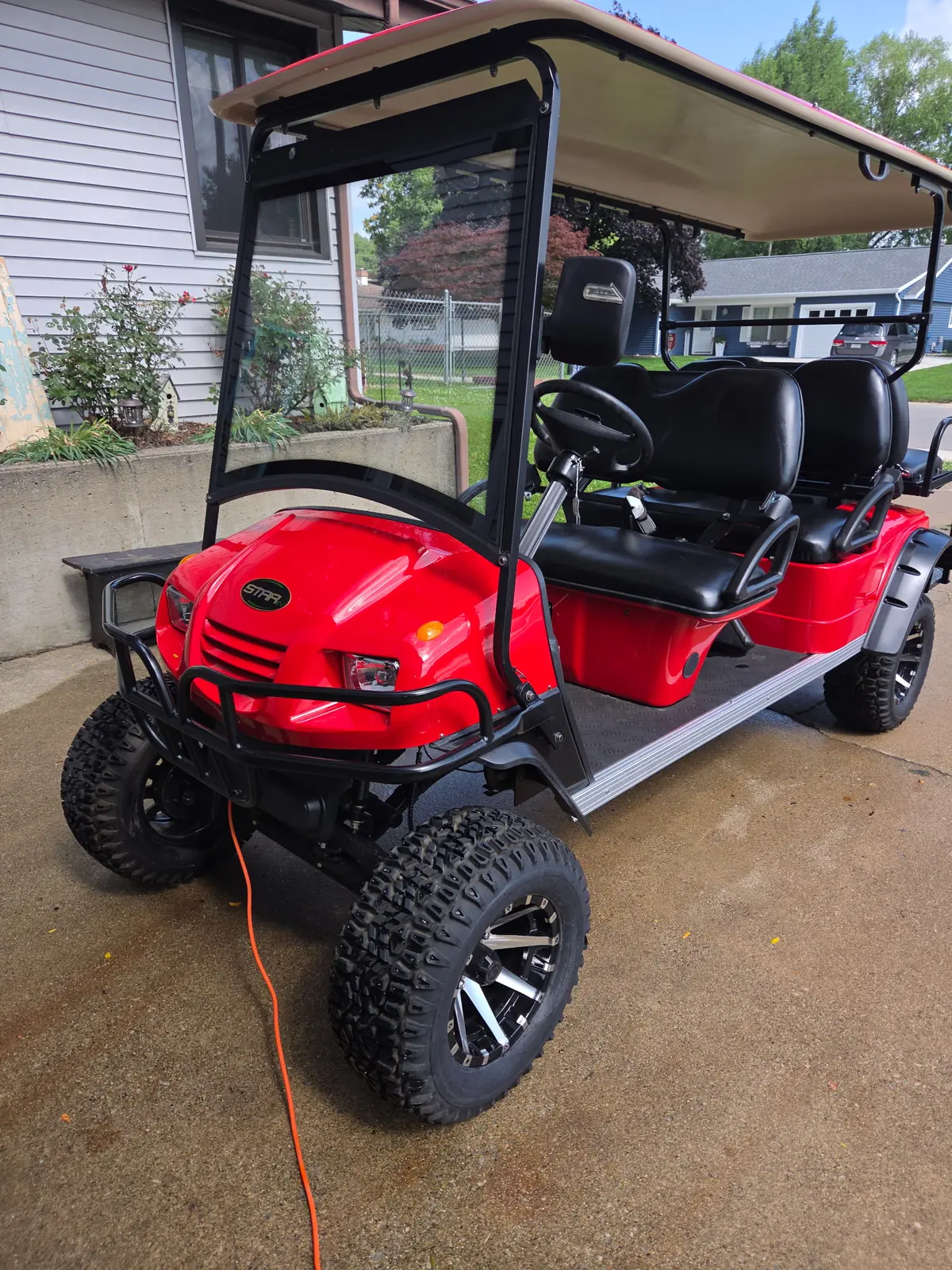 Red upgraded golf cart ready for neighborhood driving